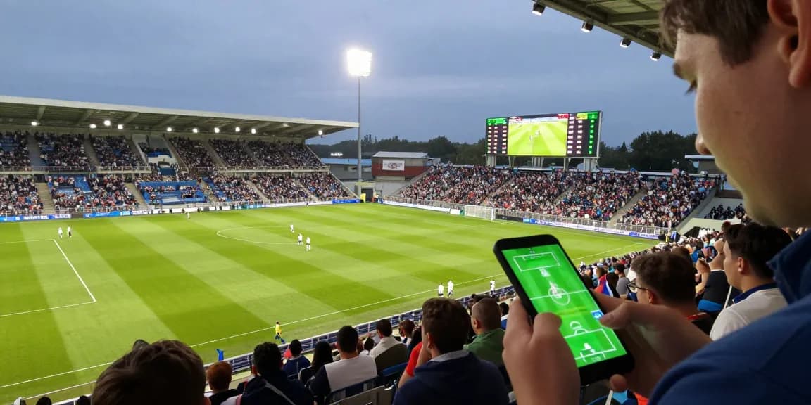 Live betting scene at a football match with bj88-vnd showcasing expert predictions and match odds.